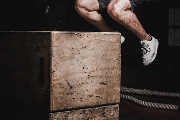 man jumping on box