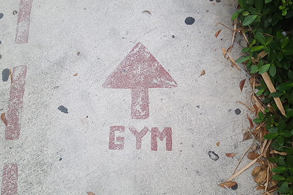 Gym this way sign on floor