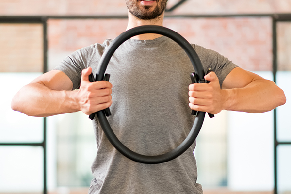 man holding pilates ring